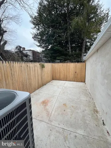 a view of roof deck with wooden fence