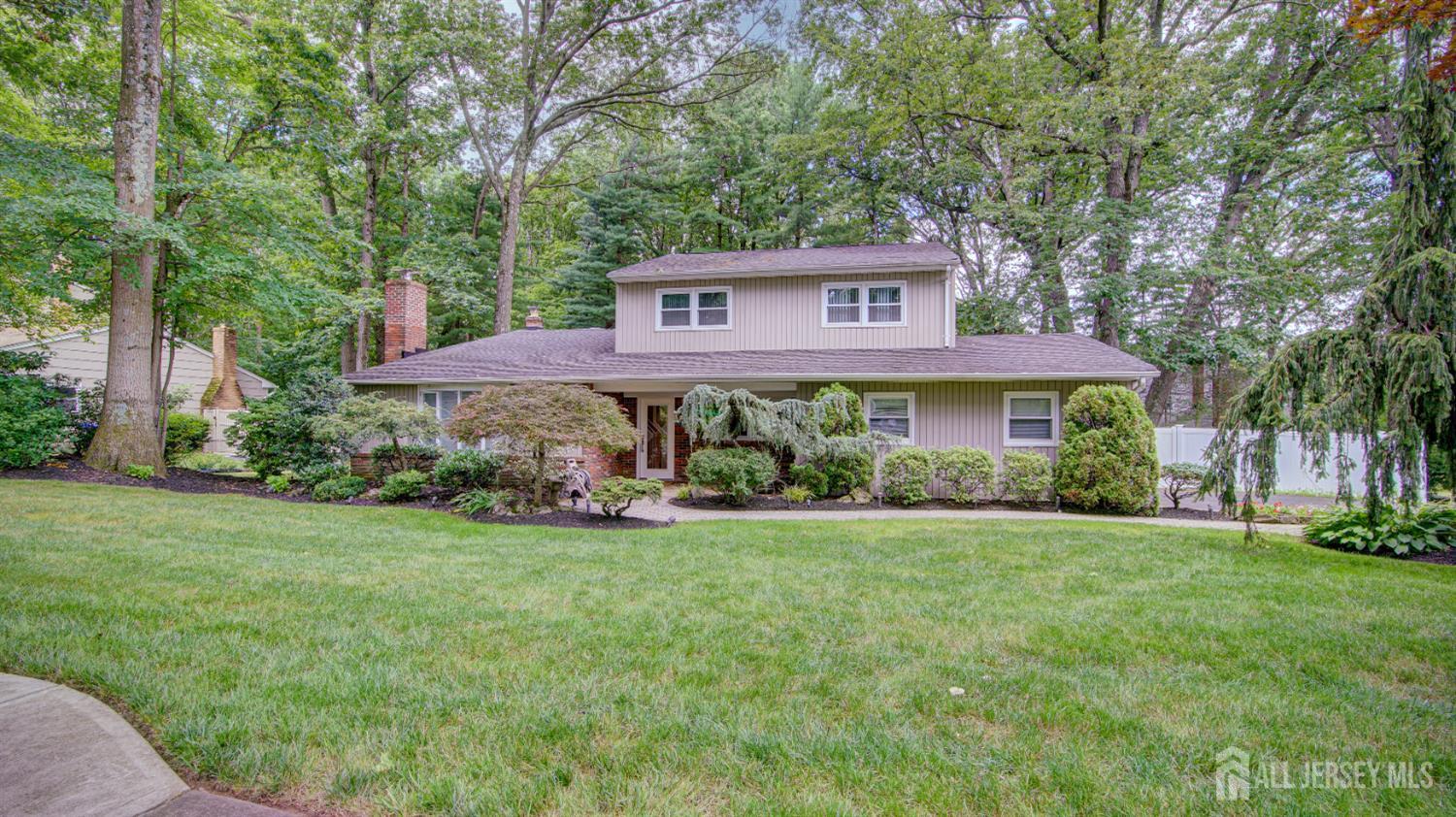 a view of a house with a yard and sitting area