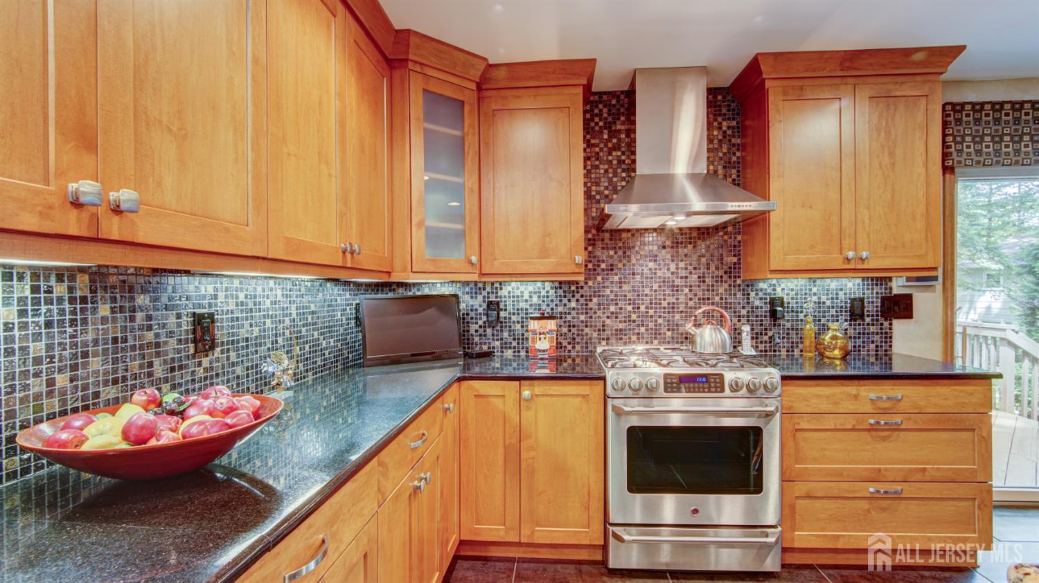 15 Timber Road East Brunswick, NJ 08816 - Photo 13 of 40 a kitchen with stainless steel appliances wooden floor and a stove top oven