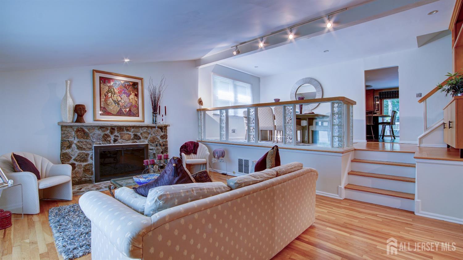 15 Timber Road East Brunswick, NJ 08816 - Photo 15 of 40 a living room with furniture two large windows and a fireplace