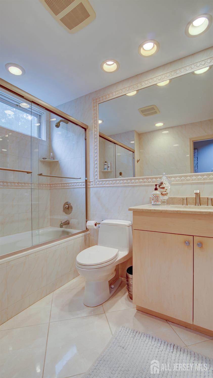 15 Timber Road East Brunswick, NJ 08816 - Photo 24 of 40 a bathroom with a double vanity sink a toilet a mirror and shower