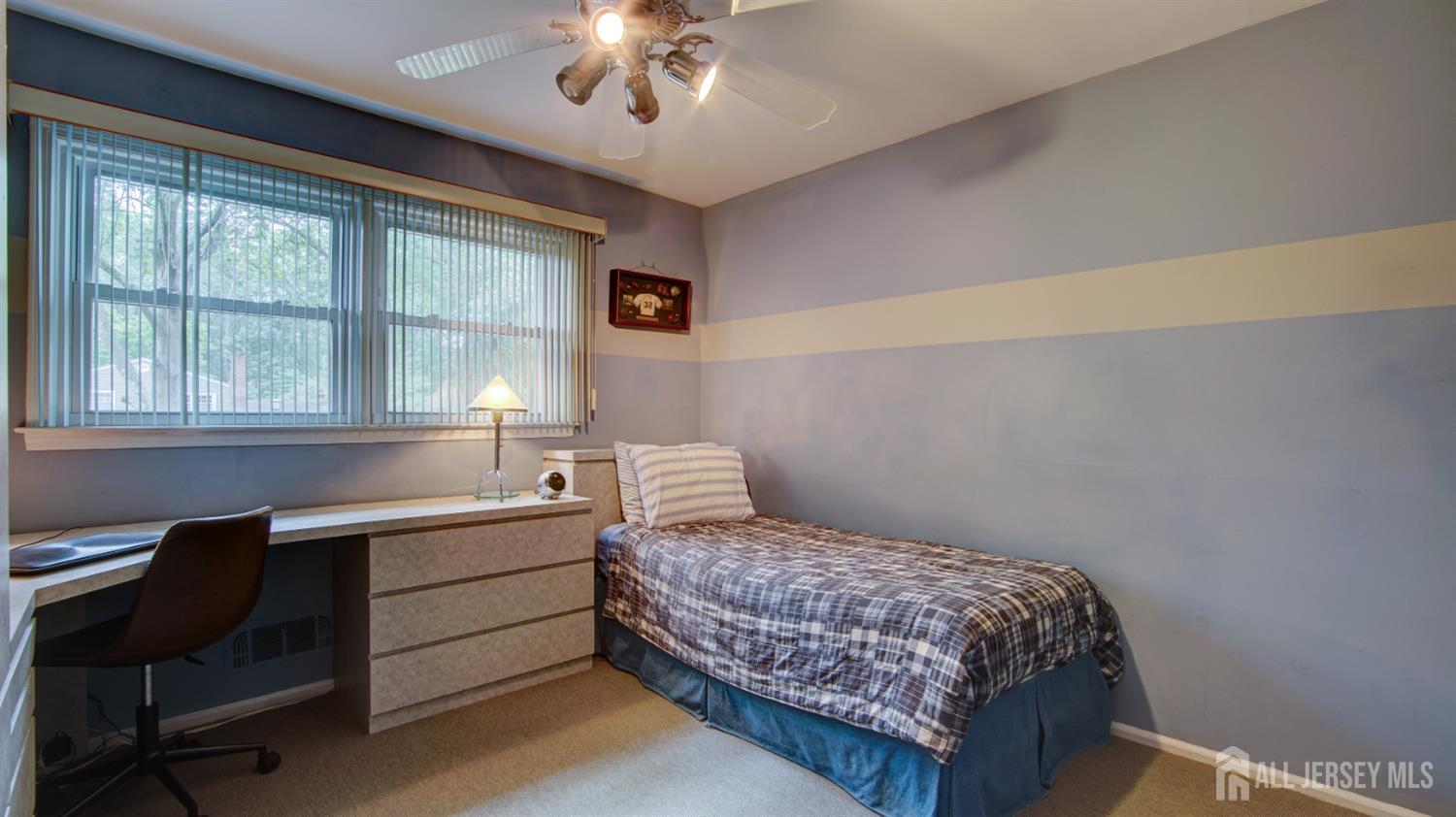 15 Timber Road East Brunswick, NJ 08816 - Photo 29 of 40 a bedroom with a large bed and a desk