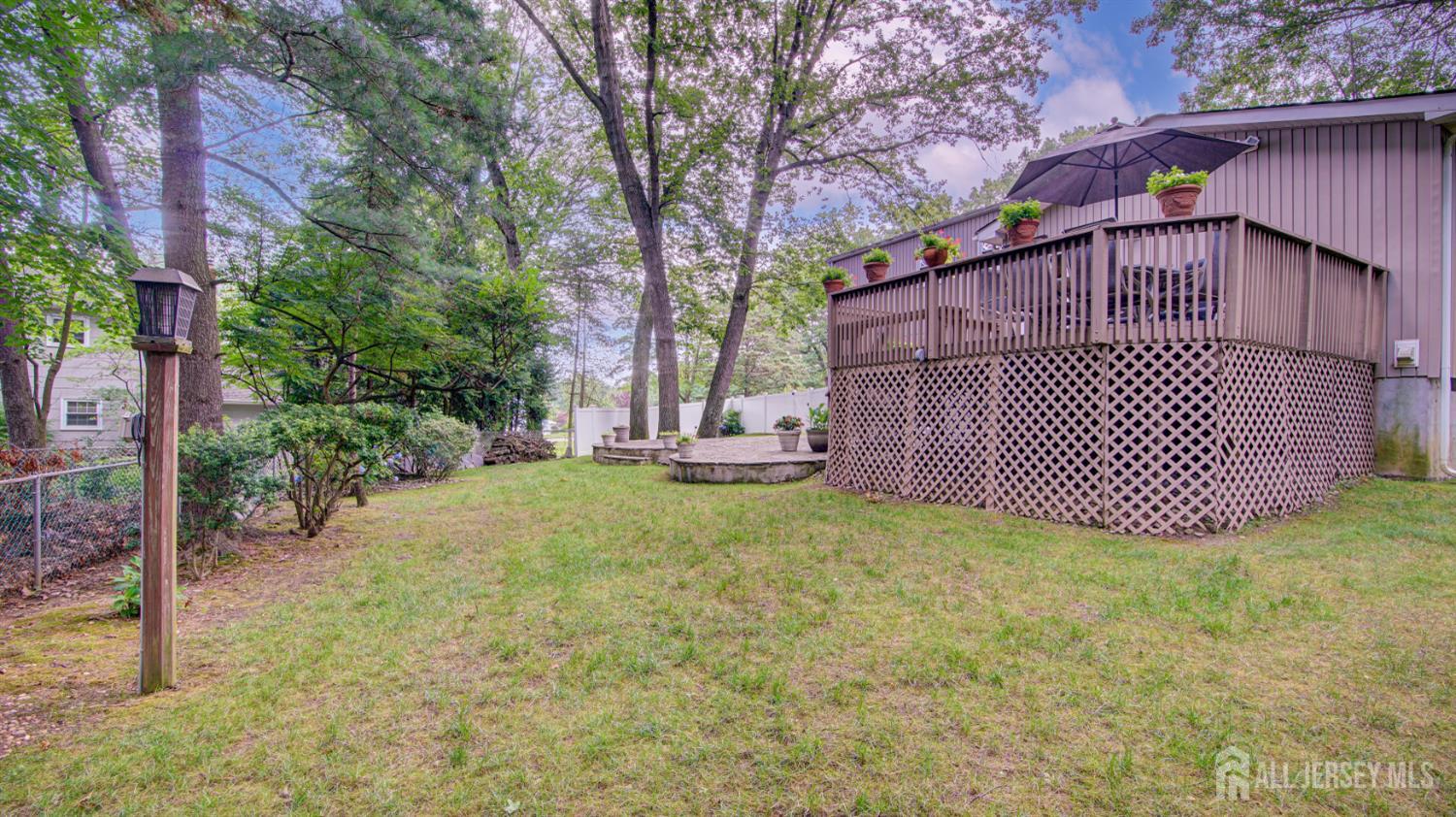 15 Timber Road East Brunswick, NJ 08816 - Photo 34 of 40 a view of a yard with wooden fence and a bench