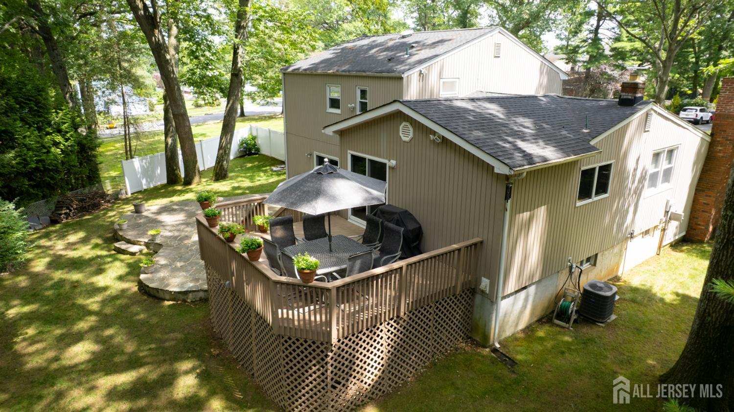 15 Timber Road East Brunswick, NJ 08816 - Photo 6 of 40 a terrace of a house with table and chairs