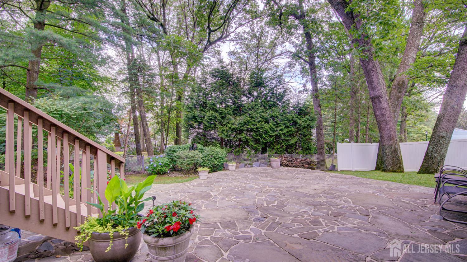 15 Timber Road East Brunswick, NJ 08816 - Photo 8 of 40 a view of a backyard with potted plants and large trees