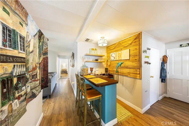 a view of a livingroom with furniture and a kitchen