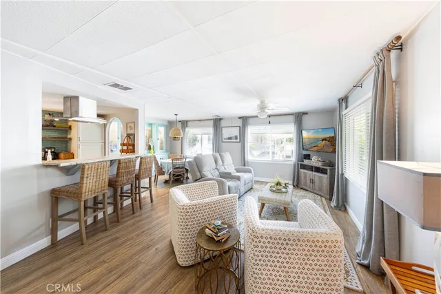 a living room with furniture a wooden floor and a fireplace