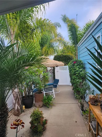 a view of a patio with table and chairs and potted plants