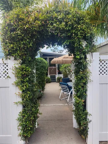 a view of a swimming pool with a yard and palm trees