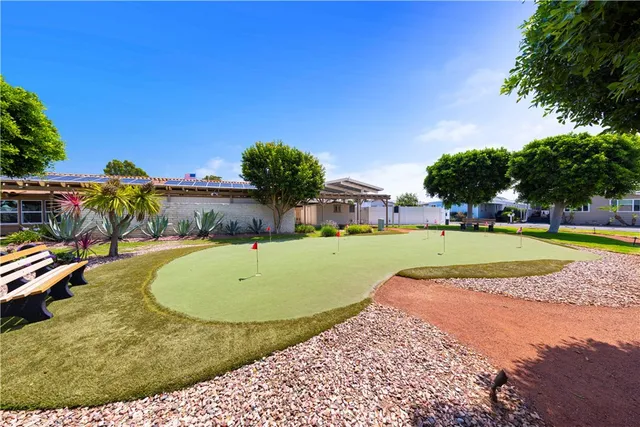 a swimming pool with outdoor seating and a patio