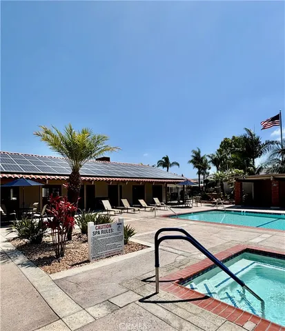 a swimming pool with outdoor seating and yard
