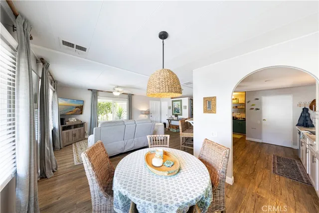 a living room with furniture and a dining table