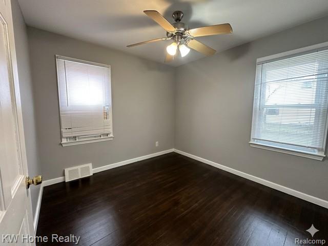 4607 Cadieux Road Detroit, MI 48224 - Photo 5 of 18 Empty room featuring dark wood-style flooring and a ceiling fan