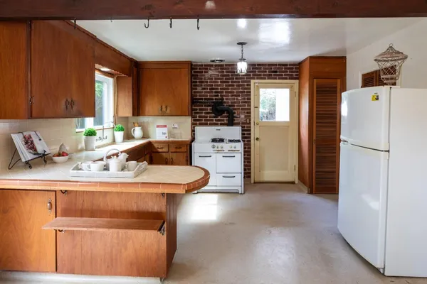 a kitchen with stainless steel appliances granite countertop a sink a stove and a refrigerator