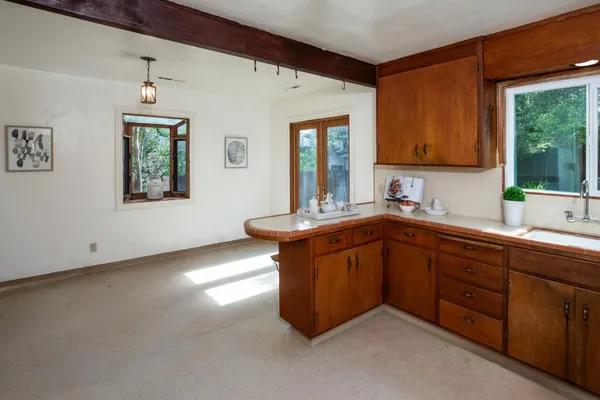 a kitchen with stainless steel appliances granite countertop a sink dishwasher and a stove with wooden floor
