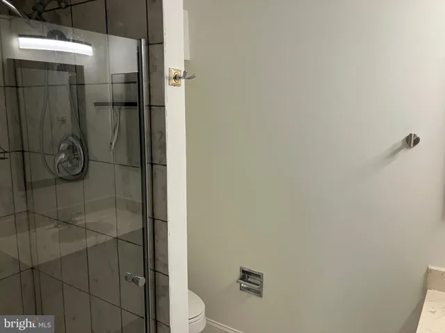 a bathroom with a shower toilet and sink