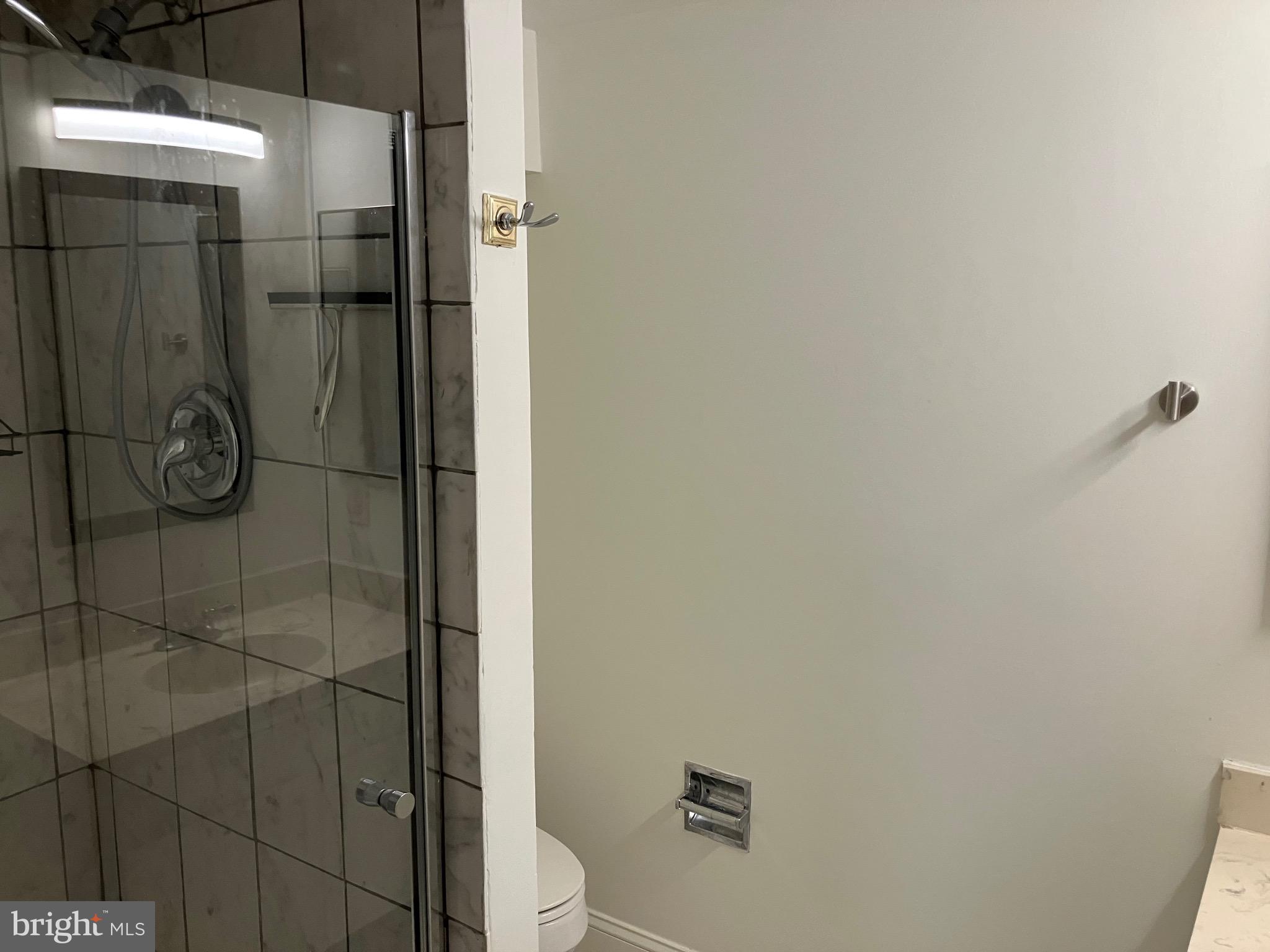 7680 Tremayne Place, Unit 201 McLean, VA 22102 - Photo 11 of 13 a bathroom with a shower toilet and sink