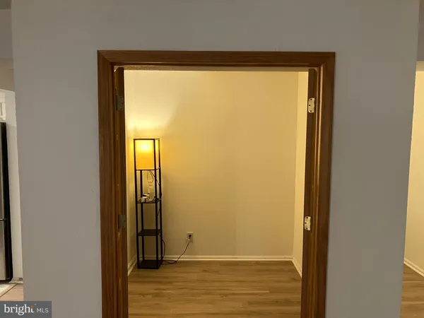a view of walk in closet with empty room