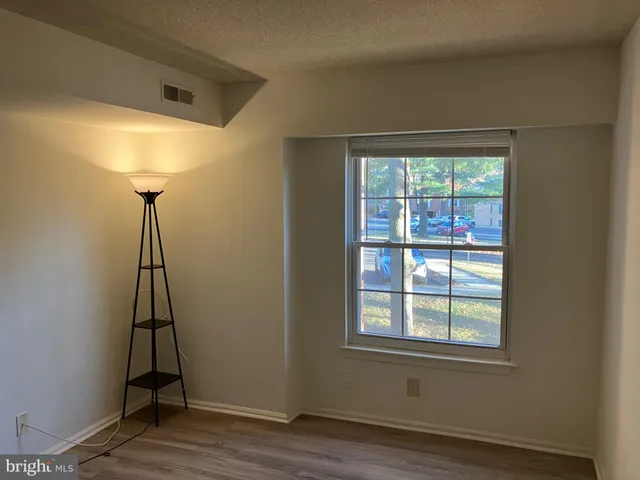 a room with a window and wooden floor