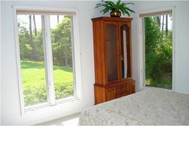 484 Shipwreck Road Santa Rosa Beach, FL 32459 - Photo 13 of 15 a bedroom with a bed and a large window