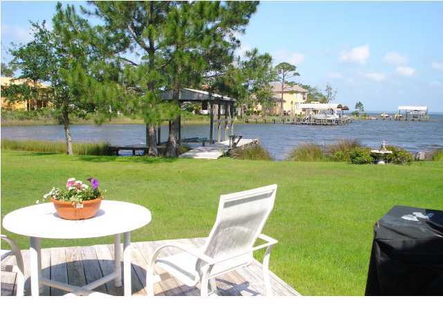 484 Shipwreck Road Santa Rosa Beach, FL 32459 - Photo 3 of 15 a backyard of a house with a yard and outdoor seating