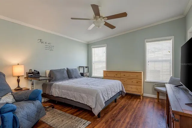 a bedroom with bed and wooden floor