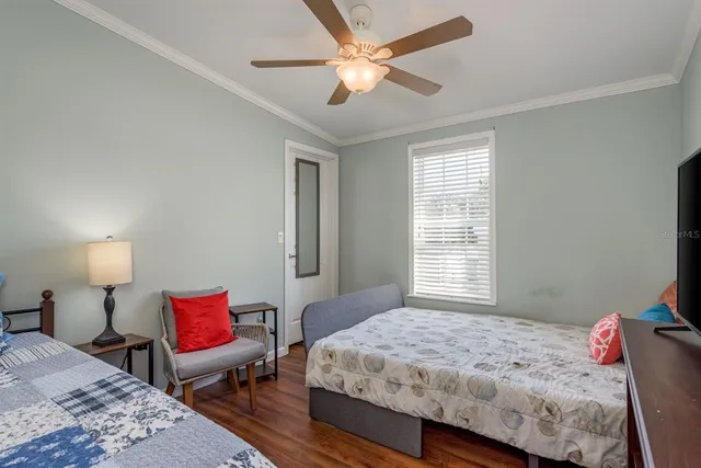 a bedroom with furniture and a flat screen tv