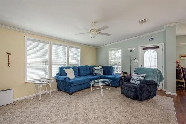 a living room with lots of furniture and kitchen view