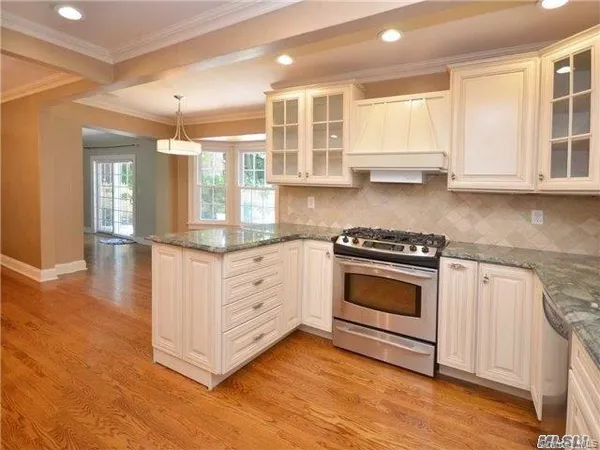 a kitchen with stainless steel appliances granite countertop a stove and a sink
