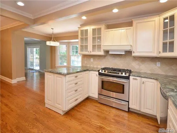a kitchen with stainless steel appliances granite countertop a stove and a sink