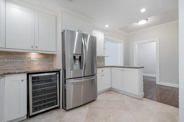 a kitchen with cabinets and stainless steel appliances