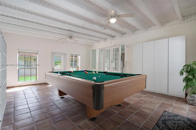 a living room with a couch and a potted plant