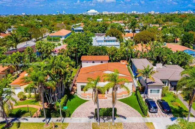 an aerial view of residential houses with outdoor space and street view