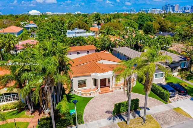an aerial view of a house with a yard basket ball court and outdoor seating