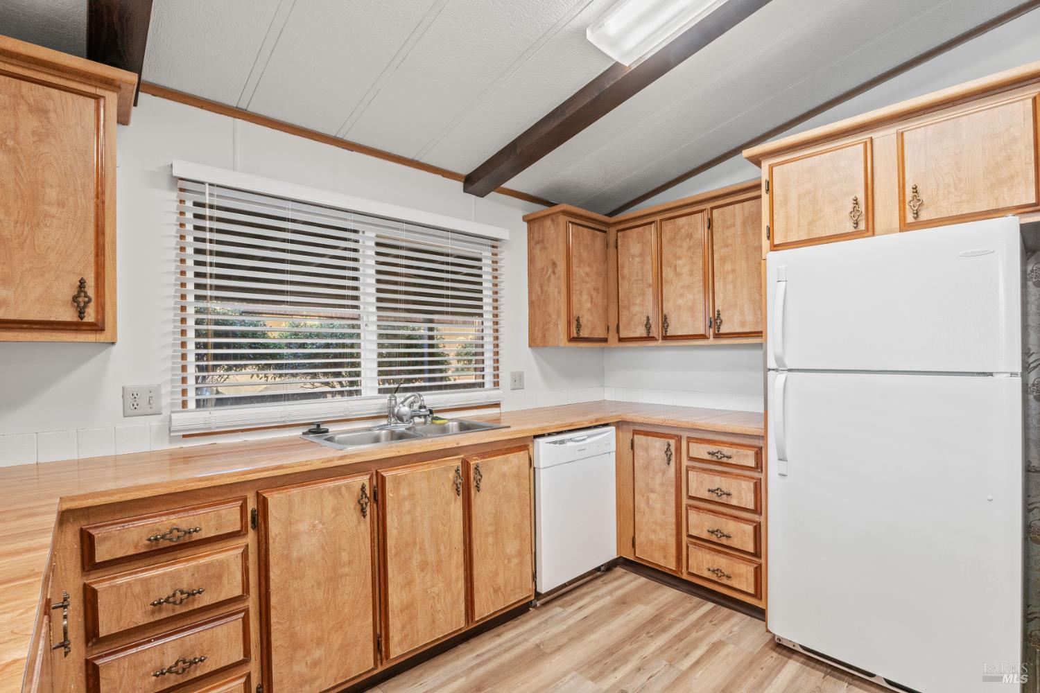 51 Rancho Grande Drive Ukiah, CA 95482 - Photo 11 of 24 a kitchen with stainless steel appliances granite countertop a refrigerator a sink dishwasher a stove and white countertops with wooden floor