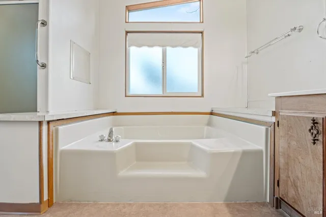 a white bath tub sitting next to a white sink