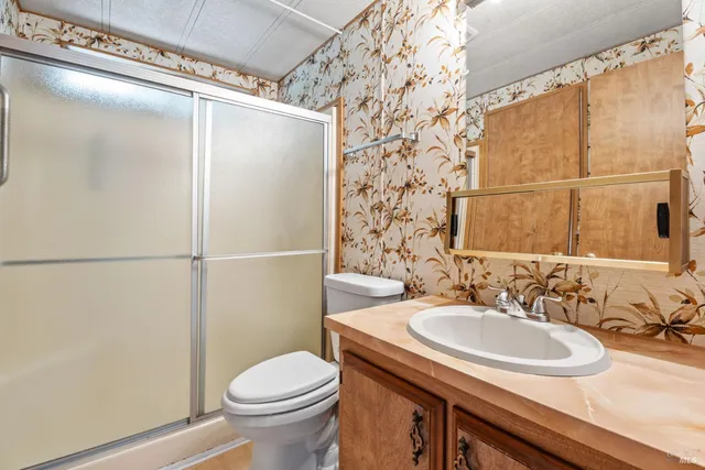 a bathroom with a sink toilet and shower