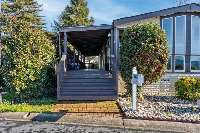 a view of a entrance gate of the house and front view of a house