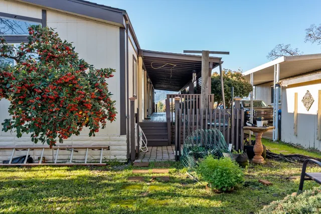 a view of a house with backyard and sitting area