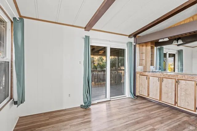 a view of an entryway with wooden floor and a window