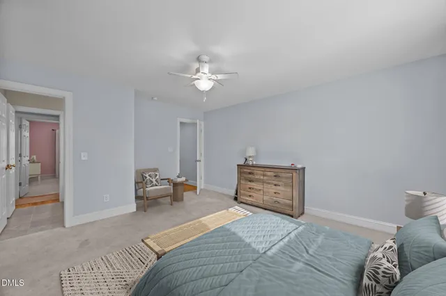 a spacious bedroom with a bed and a chandelier