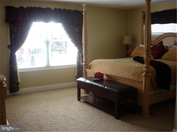 445 Kennerly Road Springfield, PA 19064 - Photo 8 of 9 a bed sitting in a bedroom next to a window