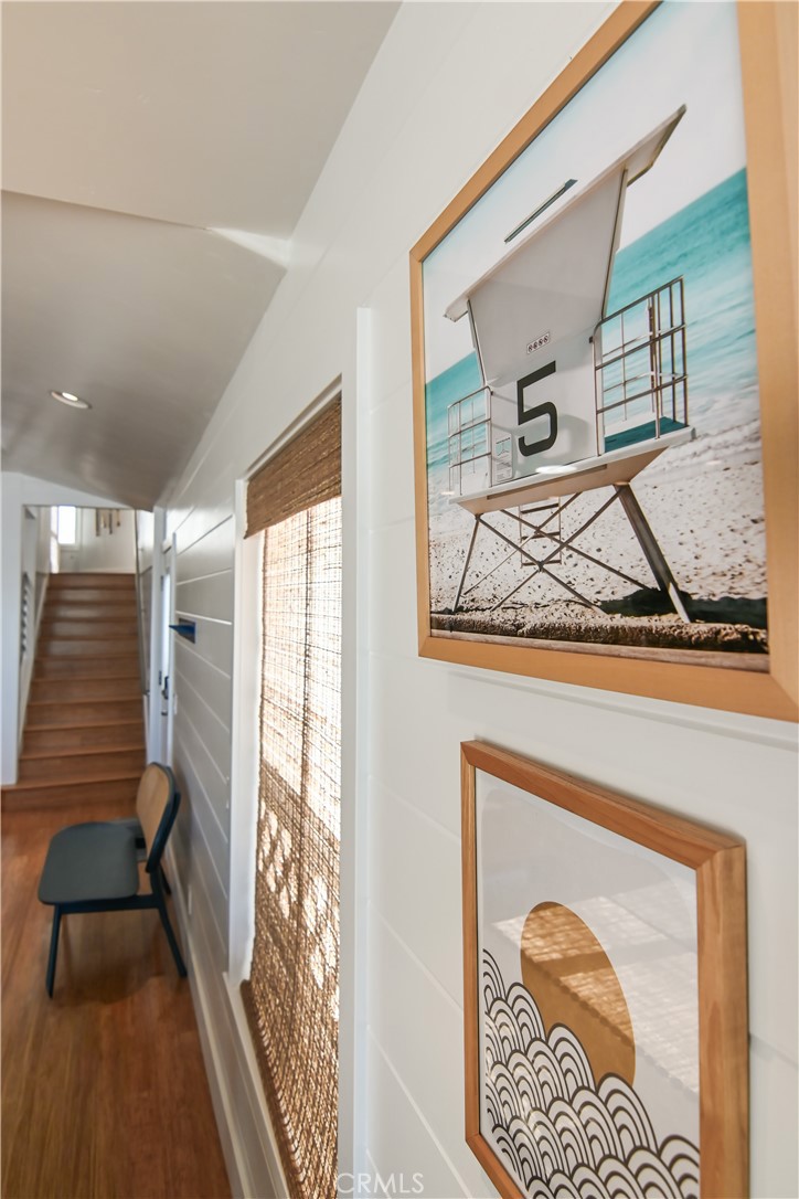 2814 Studio Drive Cayucos, CA 93430 - Photo 11 of 32 a view of a hallway with wooden floor and a large mirror