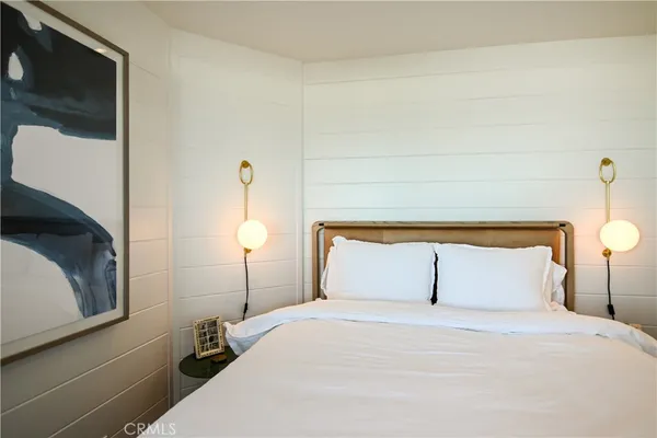 a bedroom with a bed and a lamp