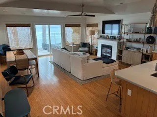 a living room with furniture a fireplace and a floor to ceiling window