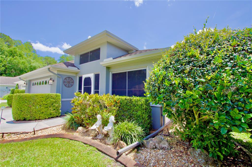 7842 Tenby Court New Port Richey, FL 34655 - Photo 22 of 27 front view of a house with a garden