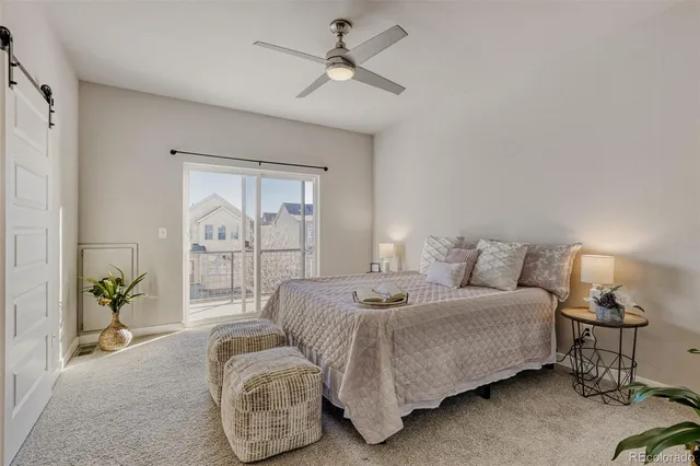 a bedroom with bed and ceiling fan