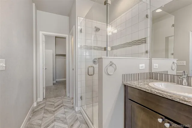 a bathroom with a shower sink and mirror