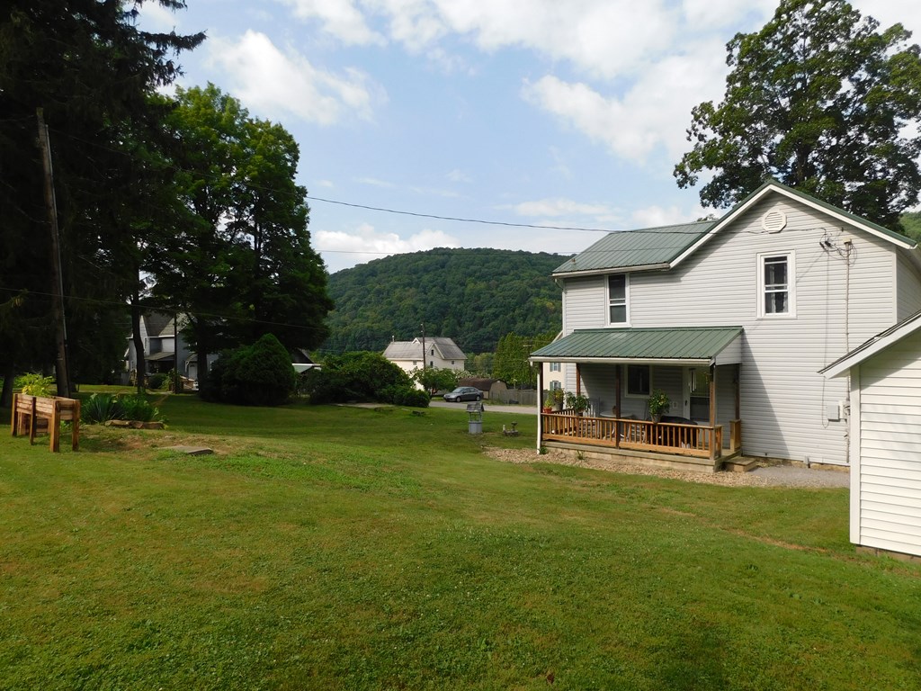204 1st Avenue Rouseville, PA 16344 - Photo 27 of 37 a view of a house with a yard porch and sitting area
