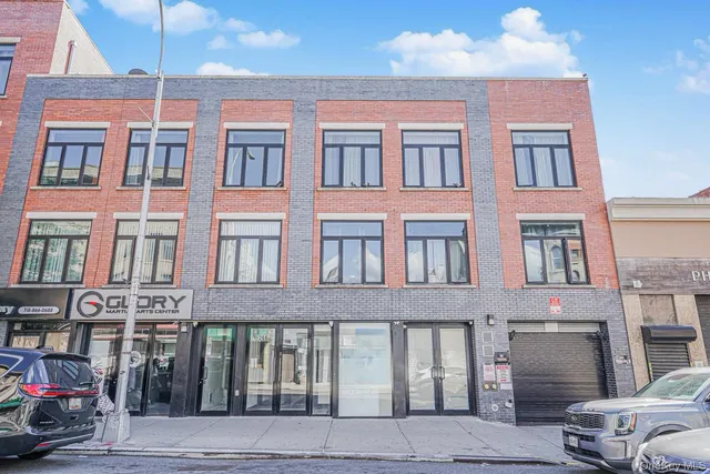 a front view of a building with parking space